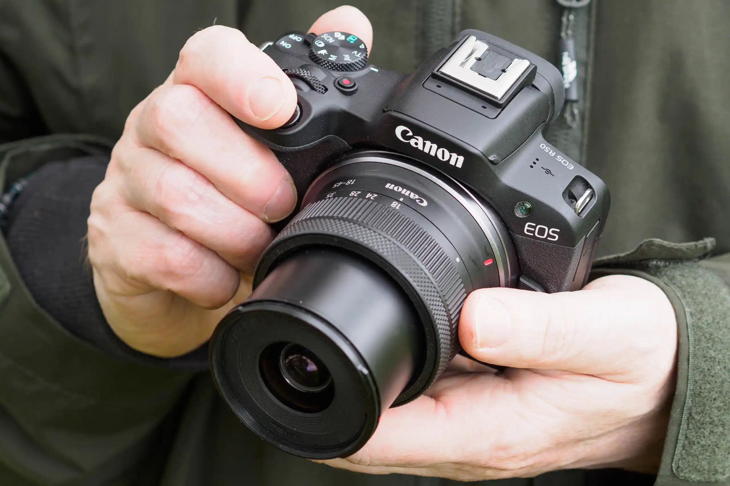 تصویر دوربین Canon EOS R50 در دست کاربر، نمایش ابعاد کوچک و ارگونومی مناسب برای عکاسی و ولاگ